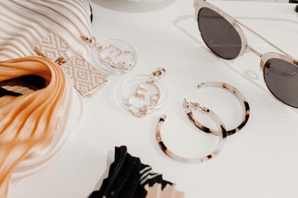an array of fashion accessories on a makeup table